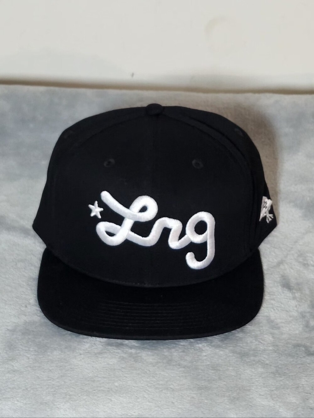 Lifted Research Group (LRG) Script Embroidered Logo Snapback Hat Color: Black/Wh